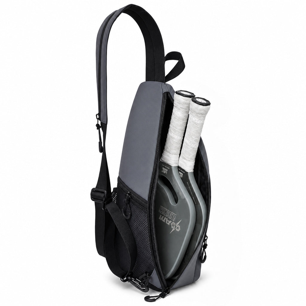 Pickleball sling backpack main compartment shown holding two paddles.