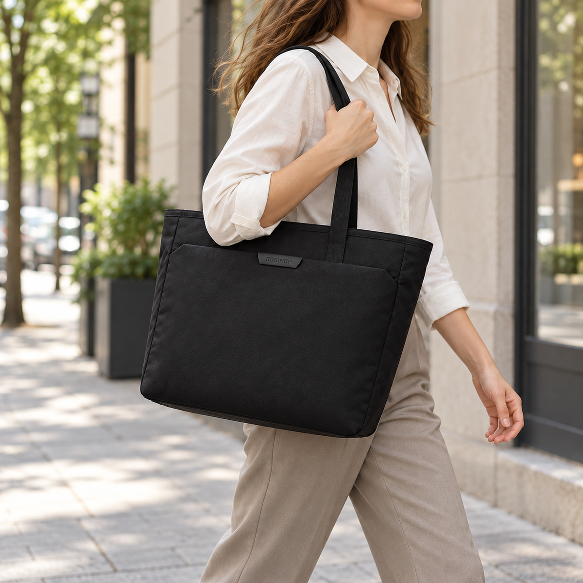 ROSINOP black organizer tote carried over the shoulder on a city commute